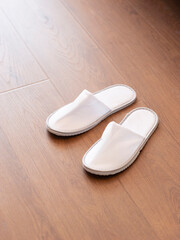 Disposable slippers at the end of the bed