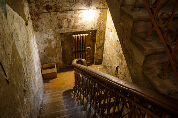 Descending down stone steps into the basement of an old mansion