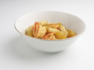 Shrimp and squid curry in white bowl