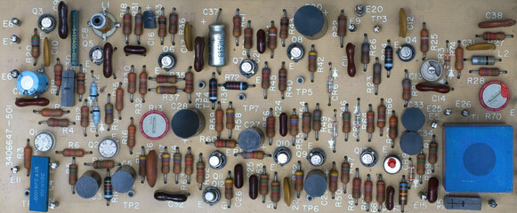 Close-up of vintage printed circuit board with various electronic components, showcasing intricate...