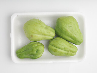 Fresh chayote on white background