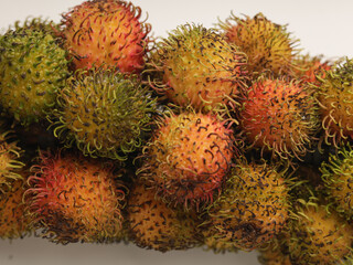 Fototapeta premium Fresh rambutan, tropical fruit, on white background