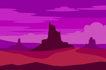 Naklejka premium Desert sunset over Monument Valley's iconic rock formations, with a vast sky and silhouetted mountains creating a stunning panorama