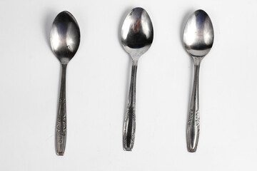 Bunch of iron spoons isolated on white background.interior home appliances