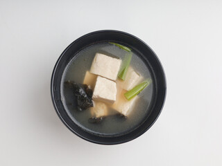 Tofu cooked in clear soup, isolated on white background
