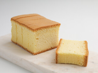 Sliced vanilla cake on white background