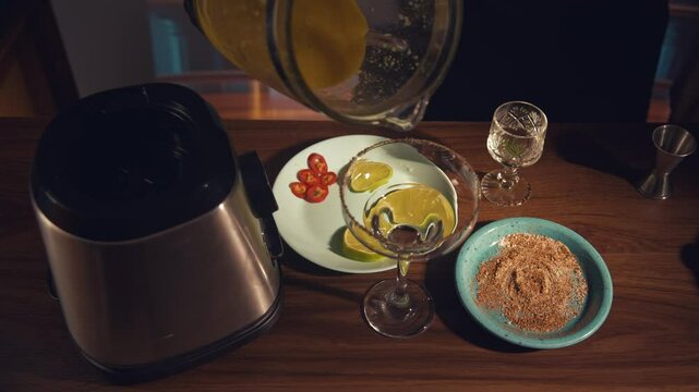 Spicy mango margarita 4 stage glass pouring