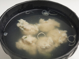 Tofu cooked in clear soup, isolated on white background
