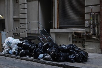 Garbage Bags Piled on New York City Sidewalk