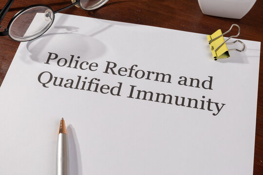 Police Reform and Qualified Immunity Document with Pen – Justice System Reform Concept