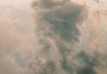 Clouds reflected in a pond surface create abstract patterns of light and shadow.
