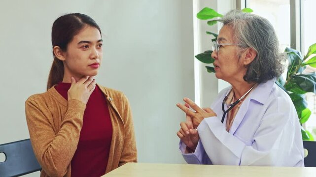 Senior female doctor provides treatment and diagnosis to female patients who are feeling unwell for physical examination and basic health care advice within the clinic.