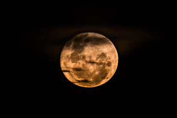 Naklejka premium June's Full moon, Strawberry Moon with bands of clouds