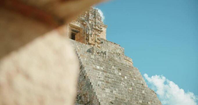 Close-up of ancient Mayan temple with stone stairway and detailed carvings