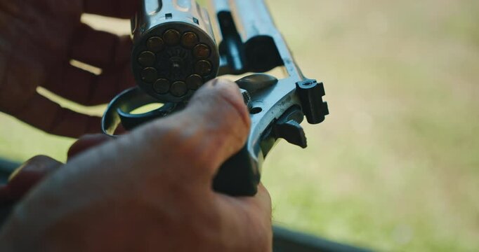 Revolver being loaded with cartridges during shooting practice