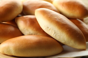 Many tasty baked patties on table, closeup