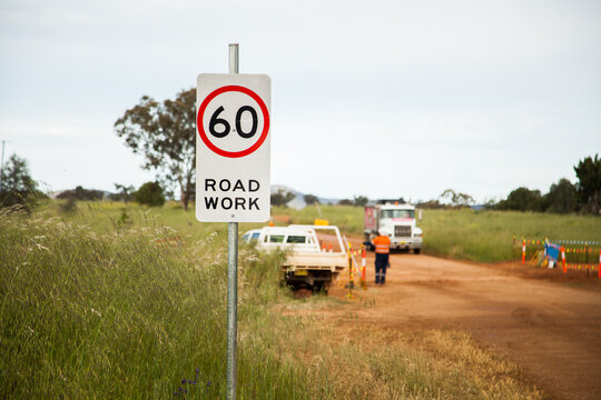 Sixty road work sign near rural highway construction