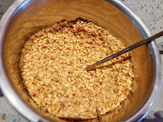 Ground peanuts in a bowl, top view