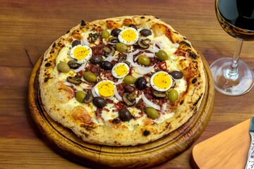 Original Brazilian pizza with olives, mushrooms, grated pepperoni, onion, red pepper, oregano and extra virgin olive oil