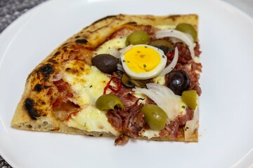 Original Brazilian pizza with olives, mushrooms, grated pepperoni, onion, red pepper, oregano and...