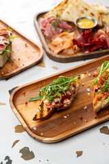 Gathering at a cozy eatery, patrons savor colorful tapas displayed on wooden trays. Fresh ingredients create an inviting atmosphere filled with delightful aromas and rich flavors