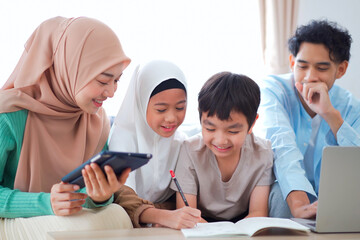 Happy Asian muslim family's portrait in living room.