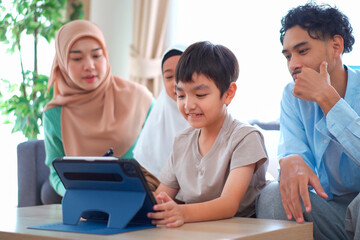 Happy Asian muslim family's portrait in living room.