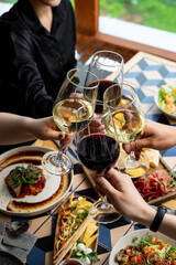 Friends gather around a beautifully laid table, raising their glasses in celebration. Delicious plates of food surround them, creating a warm and inviting atmosphere perfect for sharing joy