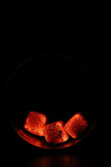 Glowing coals with glitch style lighting, enriched by noise, effect and grain details, create a mystical atmosphere in the dark. A vivid sense of heat and depth surrounds the image