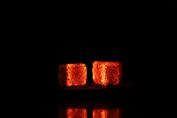 Glowing coals with glitch style lighting, enriched by noise, effect and grain details, create a mystical atmosphere in the dark. A vivid sense of heat and depth surrounds the image