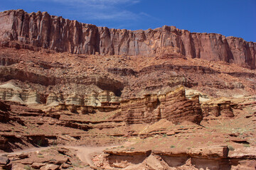 Fototapeta premium Majestic rock formations under a clear blue sky in a desert landscape during midday light