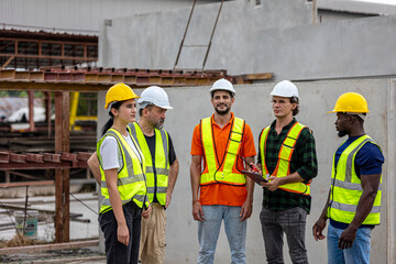 A group of civil engineers from different cultures and ethnicities exchange their ideas in a construction place or factory. People from diverse ethnic backgrounds engaging in meaningful discussions