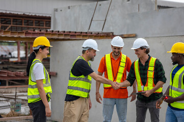 A group of civil engineers from different cultures and ethnicities exchange their ideas in a construction place or factory. People from diverse ethnic backgrounds engaging in meaningful discussions