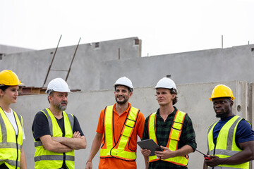 A group of civil engineers from different cultures and ethnicities exchange their ideas in a construction place or factory. People from diverse ethnic backgrounds engaging in meaningful discussions