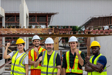 A group of civil engineers from different ethnicities and experiences stands with arms crossed expresses unity, solidarity and confidence in a factory. Inclusivity workers in a construction.