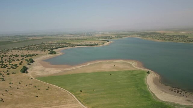 Aerial view of Djizak Reservoir shoreline with fields and unique coastline