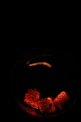 Glowing coals with glitch style lighting, enriched by noise, effect and grain details, create a mystical atmosphere in the dark. A vivid sense of heat and depth surrounds the image