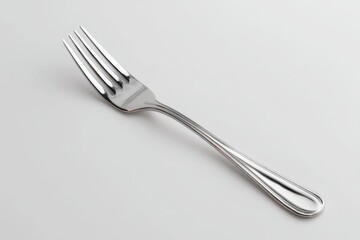 Silver fork on white surface still life