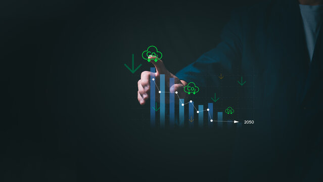 Ideas for reducing carbon emissions Businessman showing carbon tax collection graph and environmental conservation, green business, sustainable environmental development.
