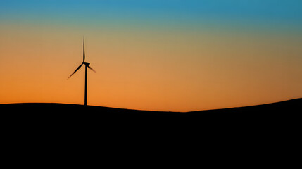 Obraz premium Wind turbine against sunset sky, symbolizing clean energy and sustainable future