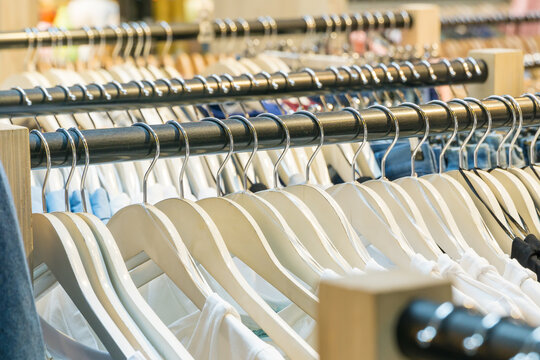 Rows of clothes racks full of clothes on hangers