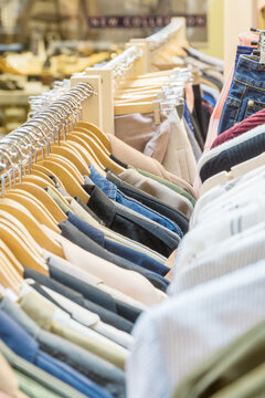 Clothes racks full of clothes on hangers