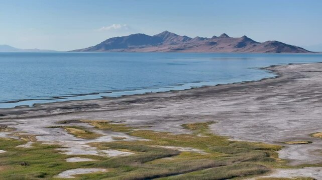 Aerial Great Salt Lake Antelope Island Utah. Largest saltwater lake in the Western Hemisphere. Solar evaporation ponds produce salt, potassium, magnesium. Recreation and industry.