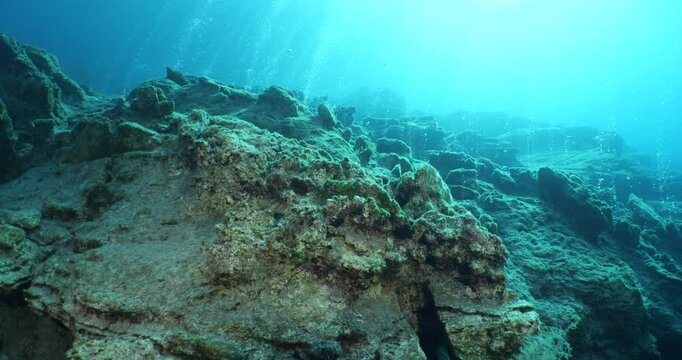 bubbles coming out of a cave underwater scuba divers to explore and enjoy