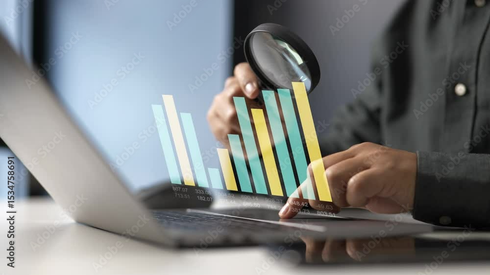 Poster analyzing digital bar graphs on a laptop with magnifying glass