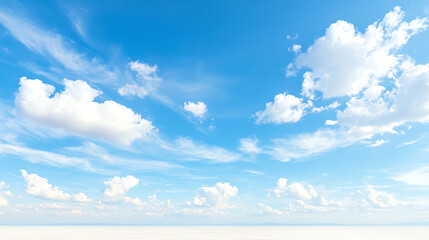 Vast blue sky with fluffy clouds, perfect for backgrounds and serene nature themes.