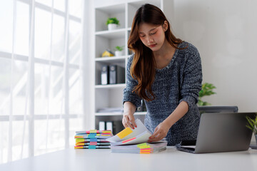 Business woman working at office with documents on his desk, doing planning analyzing the financial...