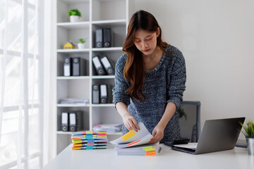 Business woman working at office with documents on his desk, doing planning analyzing the financial...