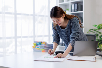 Business woman working at office with documents on his desk, doing planning analyzing the financial...