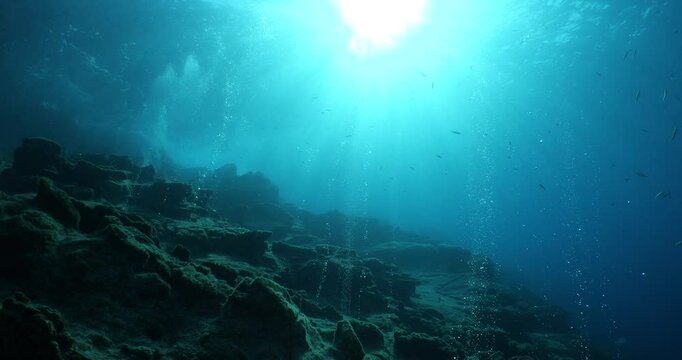 bubbles coming out of a cave underwater scuba divers to explore and enjoy